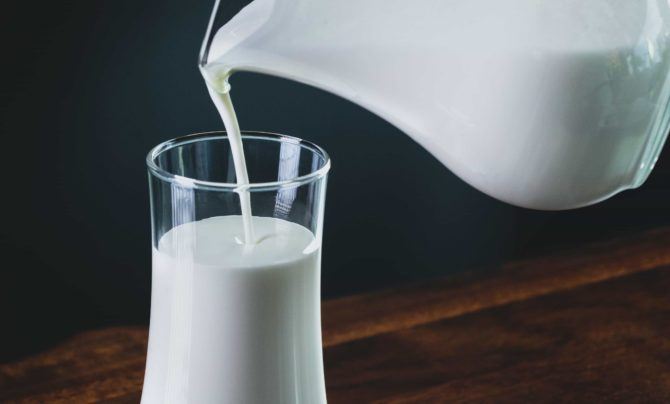 milk being poured into a glass