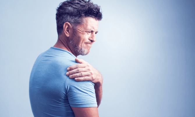 man holding shoulder in pain